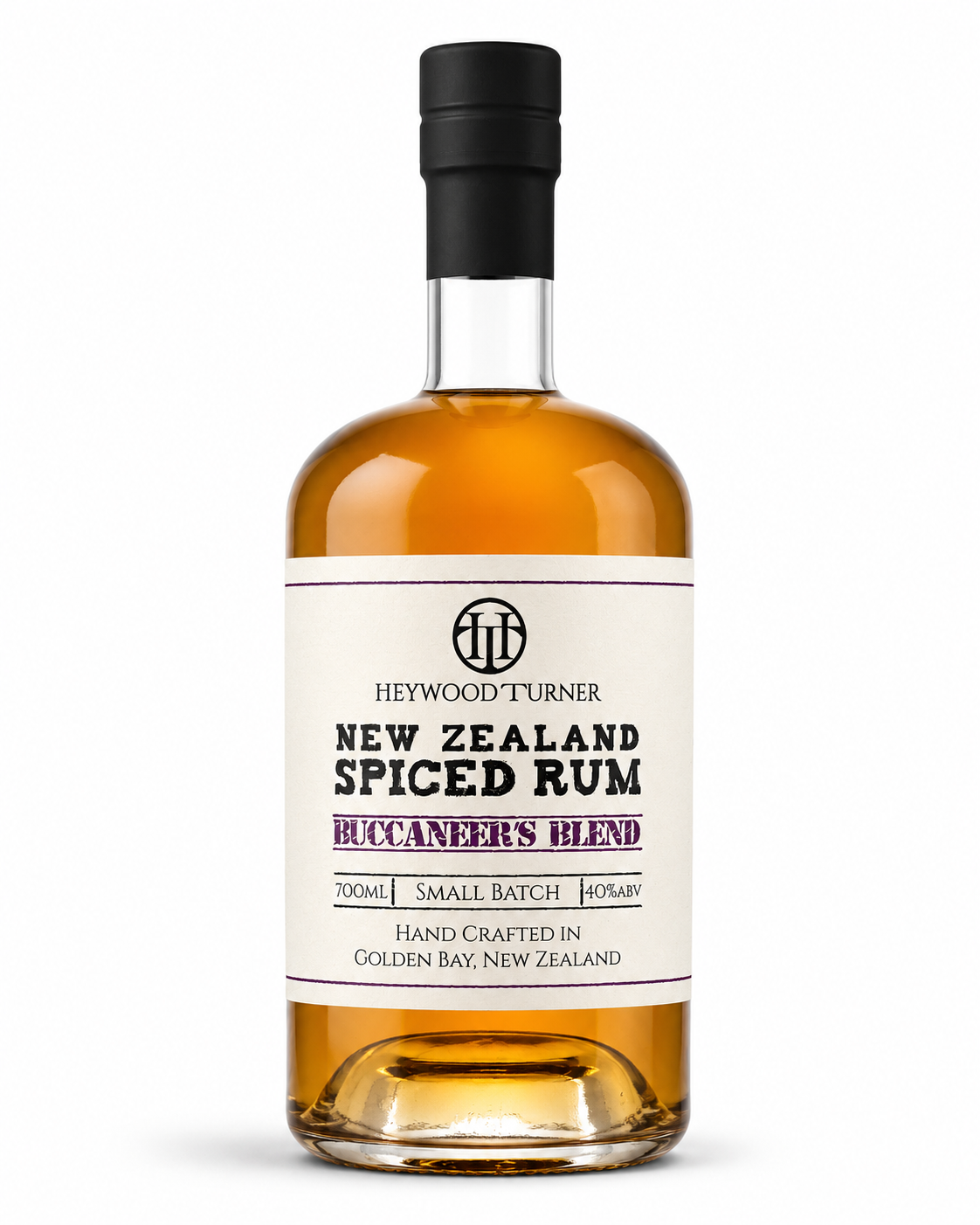 A bottle of Heywood Turner New Zealand Spiced Rum on a clean white background. The bottle is filled with amber-colored rum and features a cream-colored label with black and purple text, sealed with a black cap.